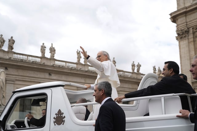 Pope Leo XIV waves as he leaves after his first weekly general audience in St. Peter's Square at The Vatican, Wednesday, May 21, 2025. (AP Photo/Gregorio Borgia)