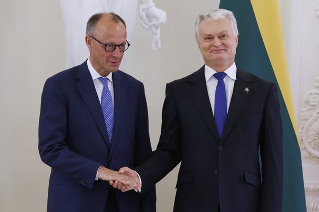 Lithuania's President Gitanas Nauseda and German Chancellor Friedrich Merz, left, shake hands prior to their meeting at the Presidential palace in Vilnius, Lithuania, Thursday, May 22, 2025. (AP Photo/Mindaugas Kulbis)