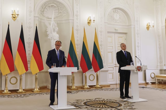 Lithuania's President Gitanas Nauseda, right, and German Chancellor Friedrich Merz , left, talk to the media at the Presidential palace in Vilnius, Lithuania, Thursday, May 22, 2025. (AP Photo/Mindaugas Kulbis)
