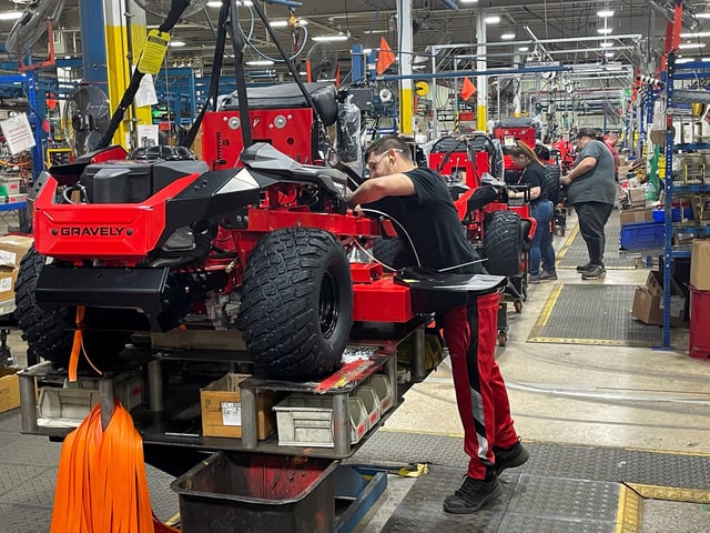 Ariens workers install parts on Gravely brand lawn mowers at a company plant in Brillion, Wisconsin, U.S., March 5, 2025. REUTERS/Tim Aeppel/File Photo