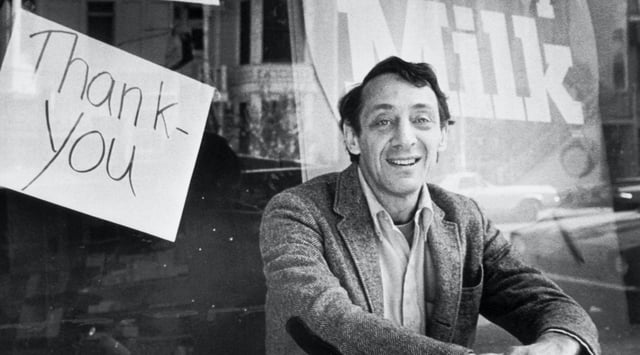 Harvey Milk sits outside his camera shop, November 9, 1977 (Bettmann/Getty)