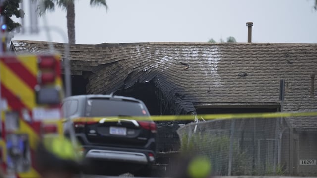 A home is damaged after a small plane crashed into a San Diego neighborhood, early Thursday, May 22, 2025. (AP Photo/Gregory Bull)