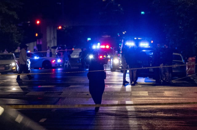 FBI agents and police officers work outside the Capital Jewish Museum following a shooting that left two people dead, in Washington, DC, in the early hours of May 22.