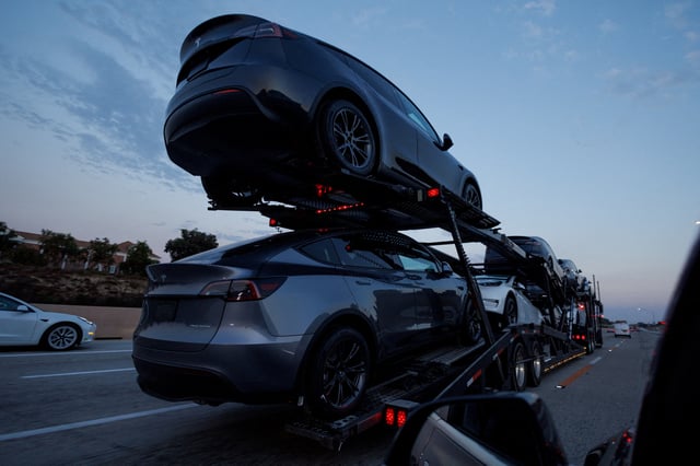 Newly manufactured Tesla Model Y SUV vehicles are transported along a freeway near Carlsbad, California, U.S., September 9, 2024.    REUTERS/Mike Blake/File Photo