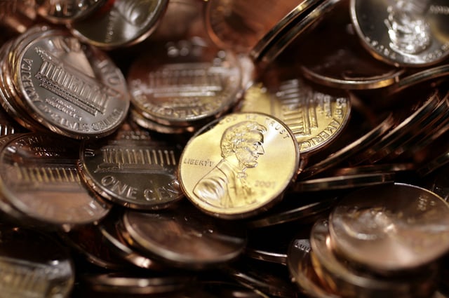 FILE - Freshly-made pennies sit in a bin at the U.S. Mint in Denver on Aug. 15, 2007. (AP Photo/David Zalubowski, File)