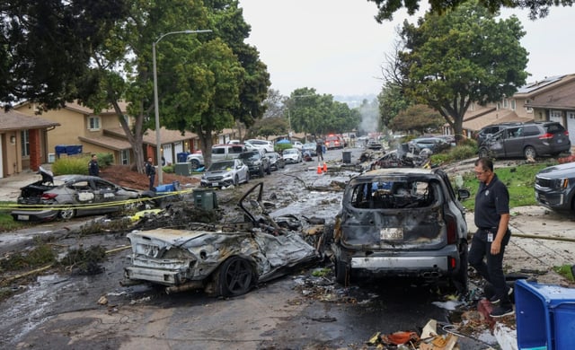 Investigators look through the site where a small plane crashed in San Diego, California on May 22, 2025