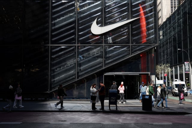 People walk past a Nike store in New York City, U.S., April 2, 2025. REUTERS/Kylie Cooper/File Photo