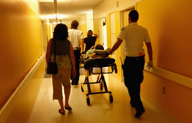 Paramedics and parents walk in an injured child into the emergency room on September 14, 2009 at the non-profit Children&#39;s Hospital in Aurora, Colorado.