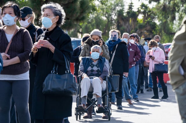People in the Phase 1B priority group wait in line to receive doses of the Moderna Covid-19 vaccine in Chula Vista, Calif., on Jan. 26, 2021.