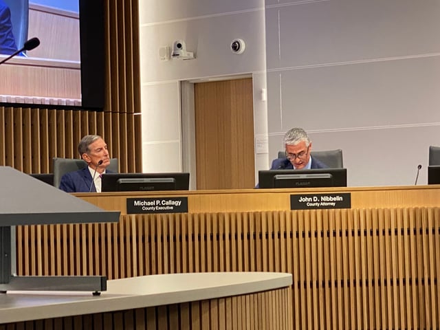 San Mateo County Executive Mike Callagy, left, and San Mateo County Attorney John Nibbelin, right, at a special Board of Supervisors meeting on Thursday, May 22. Photo by Arden Margulis.