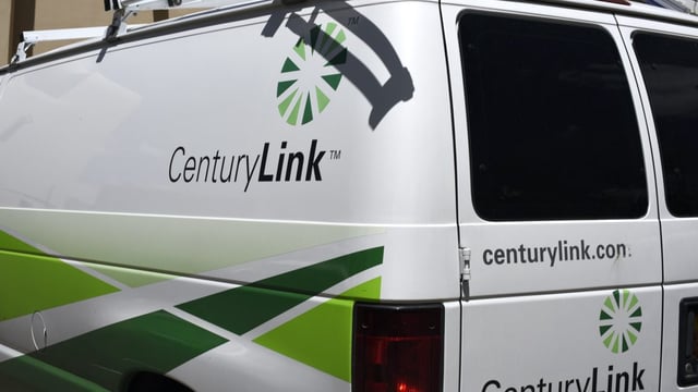 A CenturyLink service van seen from behind, with several CenturyLink logos visible.