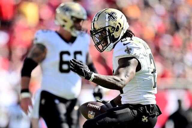 Jamaal Williams #21 of the New Orleans Saints reacts to a first down in the second quarter of the game against the Tampa Bay Buccaneers at Raymond James Stadium on January 05, 2025 in Tampa, Florida.