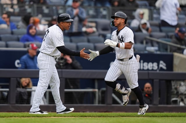 New York Yankees&#39; Jorbit Vivas celebrates with New York Yankees third base/outfield coach Luis Rojas as he runs the bases after hitting a home run during the fifth inning of a baseball game against the Texas Rangers, Thursday, May 22, 2025, in New York. (AP Photo/Frank Franklin II)