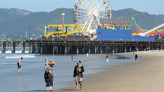 People walk the beach near the Santa Monica Pier. (Photo by David Crane, Los Angeles Daily News/SCNG)