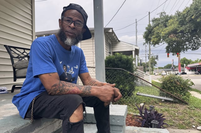Mario Westbrook sits on his porch, May 21, 2025, in New Orleans East, where he says the community has long had negative experiences with law enforcement. (AP Photo/Jack Brook)