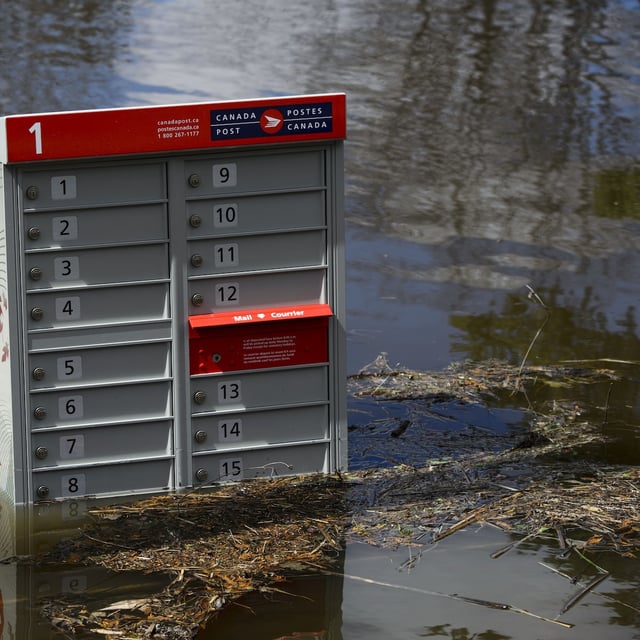 A Canada Post mailbox sits under water near the flooded banks of the Ottawa River in Cumberland, Ontario on Tuesday, April 30, 2019. THE CANADIAN PRESS/Sean Kilpatrick