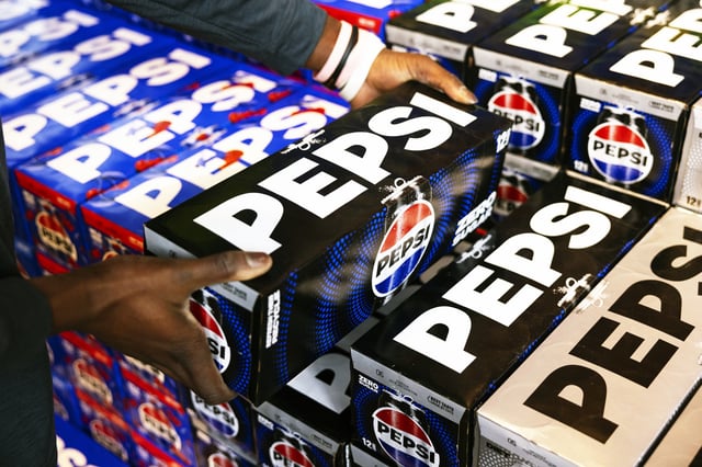 A worker stacks a case of Pepsi Zero Sugar at a supermarket in Latham, N.Y., on Feb. 2, 2024. 