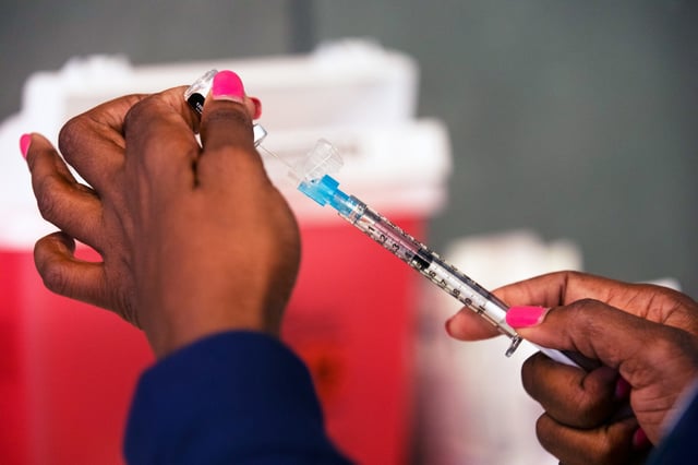 A staff member prepares a vaccine  at Martin Luther King, Jr. Community Hospital in Los Angeles in 2020.