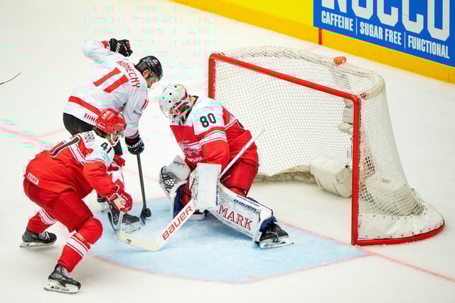 Ice Hockey - IIHF World Championships - Quarter Finals - Canada v Denmark - Jyske Bank Boxen Arena, Herning, Denmark - May 22, 2025 Canada's Travis Konecny in action with Denmark's Frederik Dichow and Jesper Jensen Aabo  Bo Amstrup/Ritzau Scanpix via REUTERS