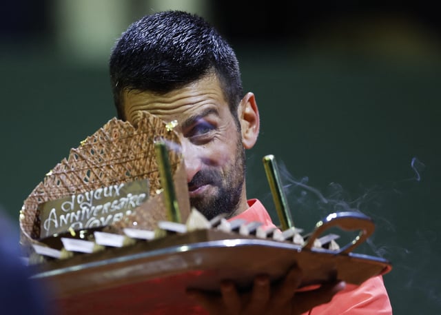 Tennis - Geneva Open - Tennis Club de Geneve, Geneva, Switzerland - May 22, 2025 Serbia's Novak Djokovic is presented with a birthday cake after winning his quarter final match against Italy's Matteo Arnaldi REUTERS/Stefan Wermuth