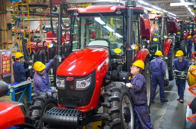 Employees work on the tractor assembly line at a YTO Group Corporation factory in Luoyang, Henan Province of China, on May 6.