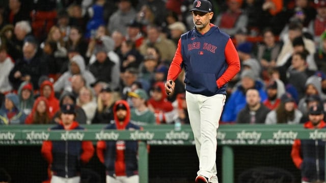 May 21, 2025; Boston, Massachusetts, USA; Boston Red Sox manager Alex Cora (13) walks to the mound during the sixth inning against the New York Mets at Fenway Park. Mandatory Credit: Eric Canha-Imagn Images