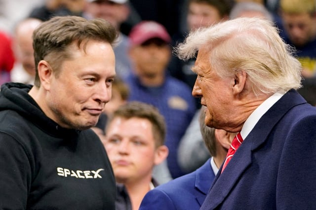 Tesla CEO Elon Musk greets U.S. President Donald Trump as they attend the NCAA men's wrestling championships in Philadelphia, Pennsylvania, U.S., March 22, 2025. REUTERS/Nathan Howard/File Photo