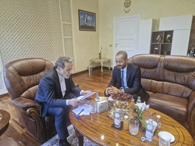 In this photo released by the Iranian Foreign Ministry, Iranian Foreign Minister Abbas Araghchi, left, reads a paper in a meeting with his Omani counterpart Sayyid Badr Albusaidi at the Omani Embassy in Rome during the fifth round of Iran-U.S. negotiations, Friday, May 23, 2025. (Iranian Foreign Ministry via AP)