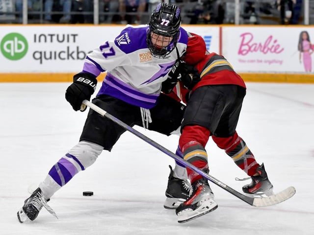 Britta Curl-Salemme of the Minnesota Frost loses the puck after the physical play of the Ottawa Charge's Ashton Bell.