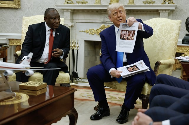 U.S. President Donald Trump holds up a printed article from &#34;American Thinker&#34; while accusing South Africa President Cyril Ramaphosa of state-sanctioned violence against white farmers in South Africa during a press availability in the Oval Office at the White House on May 21, 2025 in Washington, DC.