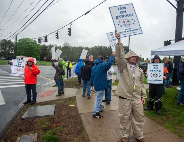 Pratt &amp; Whitney employees hold signs while picketing at the Silver Lane entrance in East Hartford on the first day of their strike, Monday, May 5, 2025. (Aaron Flaum/Hartford Courant)