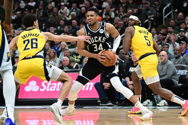 Apr 27, 2025; Milwaukee, Wisconsin, USA; Milwaukee Bucks forward Giannis Antetokounmpo (34) looks for a shot against Indiana Pacers guard Ben Sheppard (26) and  forward Jarace Walker (5) in the third quarter during game four of first round for the 2024 NBA Playoffs at Fiserv Forum. Mandatory Credit: Benny Sieu-Imagn Images