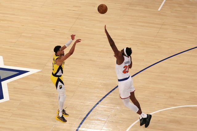 NEW YORK, NEW YORK - MAY 21:  Tyrese Haliburton #0 of the Indiana Pacers attempts a three point basket against Mitchell Robinson #23 of the New York Knicks during the third quarter in Game One of the Eastern Conference Finals of the 2025 NBA Playoffs at Madison Square Garden on May 21, 2025 in New York City. NOTE TO USER: User expressly acknowledges and agrees that, by downloading and or using this photograph, User is consenting to the terms and conditions of the Getty Images License Agreement. (Photo by Al Bello/Getty Images)