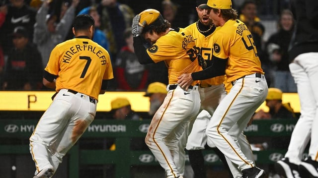 The Pittsburgh Pirates’ Adam Frazier (26) celebrates with teammates after scoring on a wild pitch during the 10th inning against the Milwaukee Brewers at PNC Park on Friday, May 23, 2025, in Pittsburgh. (Joe Sargent/Getty Images/TNS)