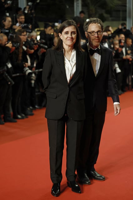 Director Ethan Coen and Tricia Cooke pose on the red carpet during arrivals for the screening of the film "Honey Don't!" presented as part of midnight screenings at the 78th Cannes Film Festival in Cannes, France, May 24, 2025. REUTERS/Manon Cruz