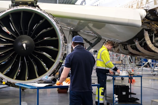 Technicians work on engine