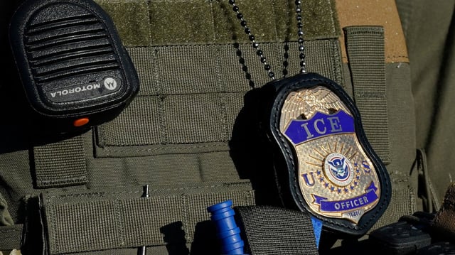 An Immigration and Customs Enforcement agent stands near an immigrant detention center in Elizabeth, New Jersey, on May 7, 2025.