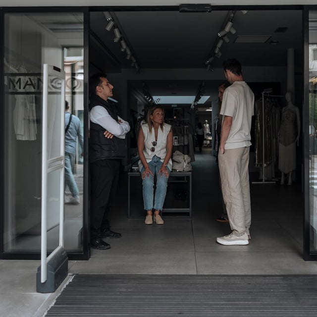 Shop employees wait during an electricity outage in Cannes, southern France, on May 24.