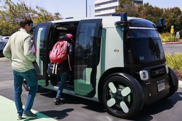 Zoox employees enter a self-driving robotaxi in July 2024. The autonomous vehicle company has issued its second voluntary software recall in a month after a collision between one of its robotaxis and an electric scooter in San Francisco.