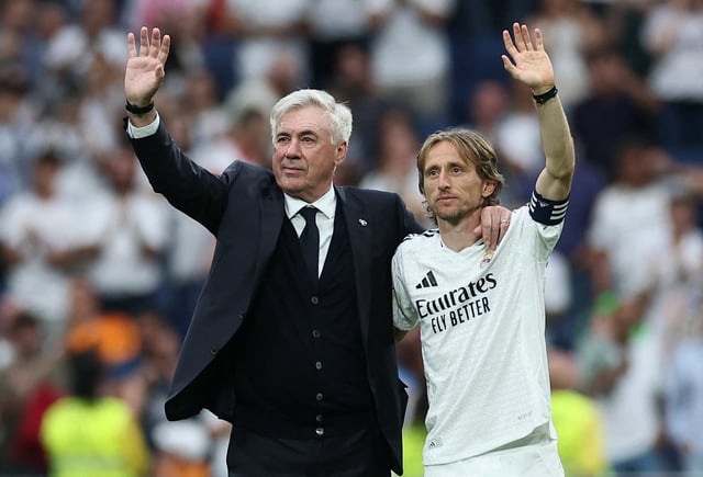 Soccer Football - LaLiga - Real Madrid v Real Sociedad - Santiago Bernabeu, Madrid, Spain - May 24, 2025 Real Madrid coach Carlo Ancelotti acknowledges fans on the pitch after his last match as Real Madrid coach and Real Madrid's Luka Modric reacts after he played his last LaLiga match for Real Madrid REUTERS/Isabel Infantes