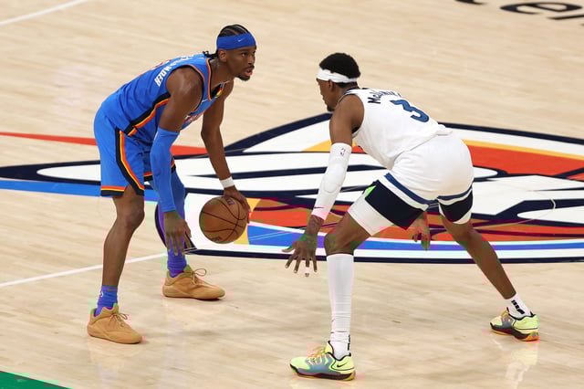 OKLAHOMA CITY, OKLAHOMA - MAY 22: Shai Gilgeous-Alexander #2 of the Oklahoma City Thunder dribbles in front of Jaden McDaniels #3 of the Minnesota Timberwolves during the fourth quarter in Game Two of the Western Conference Finals of the 2025 NBA Playoffs at Paycom Center on May 22, 2025 in Oklahoma City, Oklahoma.