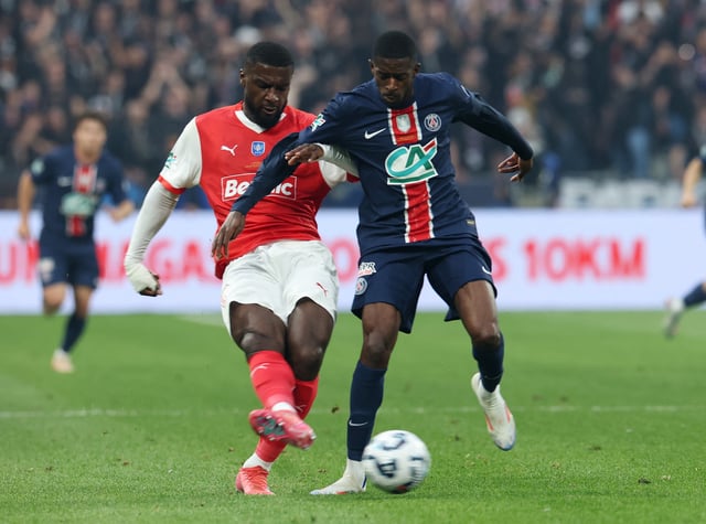Soccer Football - Coupe de France - Final - Paris St Germain v Stade de Reims - Stade de France, Saint-Denis, France - May 24, 2025 Stade de Reims' Cedric Kipre in action with Paris St Germain's Ousmane Dembele REUTERS/Denis Balibouse