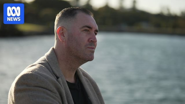 A man stares contemplatively out over the ocean