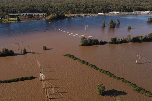 A drone view shows a boat at a flooded stud farm near the Hunter River in Heatherbrae, Australia, May 24, 2025. REUTERS/Hollie Adams