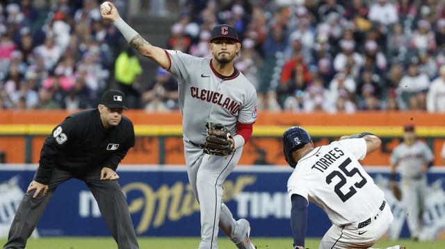 May 24, 2025; Detroit, Michigan, USA; Cleveland Guardians second baseman Gabriel Arias (13) throws to first after tagging Detroit Tigers second base Gleyber Torres (25) out at second during the fifth inning at Comerica Park. Mandatory Credit: Brian Bradshaw Sevald-Imagn Images