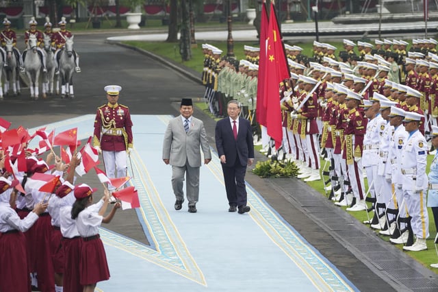 Chinese Premier Li Qiang, right, with Indonesian President Prabowo Subianto, inspects honor guards during the welcoming ceremony ahead of their meeting in Jakarta, Indonesia, Sunday, May 25, 2025. (AP Photo/Achmad Ibrahim)