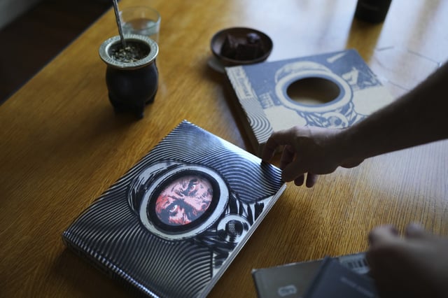 Martin Oesterheld holds an English version of sci-fi comic, "The Eternaut," written by his grandfather Hector Oesterheld, during an interview in Buenos Aires, Argentina, Tuesday, May 13, 2025. (AP Photo/Rodrigo Abd)