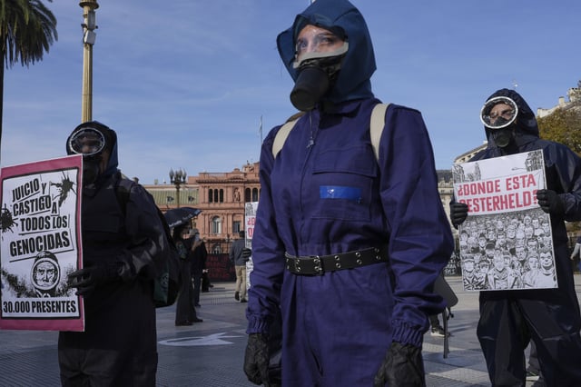 Human rights activists stage a performance calling for continued efforts to locate children disappeared during Argentina's military dictatorship (1976–1983), including grandchildren of sci-fi comic author Hector Oesterheld, whose work inspired the Netflix series "The Eternaut," in Buenos Aires, Argentina, Tuesday, May 13, 2025. (AP Photo/Rodrigo Abd)