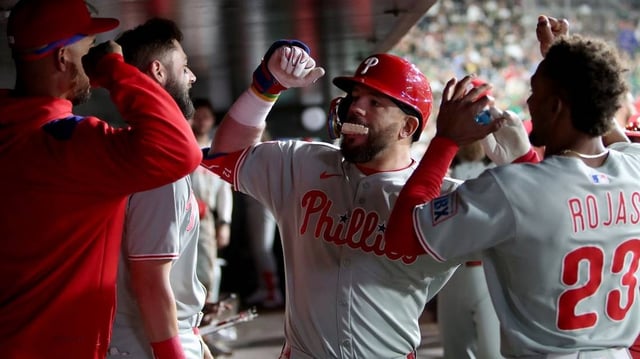 May 24, 2025; West Sacramento, California, USA; Philadelphia Phillies designated hitter Kyle Schwarber (12) is congratulated by teammates in the dugout after hitting a solo home run against the Athletics during the sixth inning at Sutter Health Park. Mandatory Credit: Dennis Lee-Imagn Images