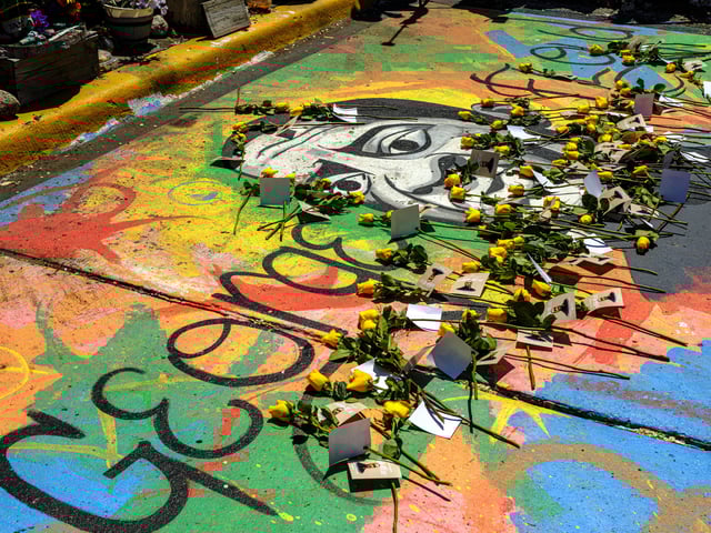 A mural of George Floyd at George Floyd Square is adorned with yellow roses and paper notes at George Floyd Square, May 23, 2025, in Minneapolis, Minnesota, during a tribute marking nearly five years since Floyd&#39;s killing by police.